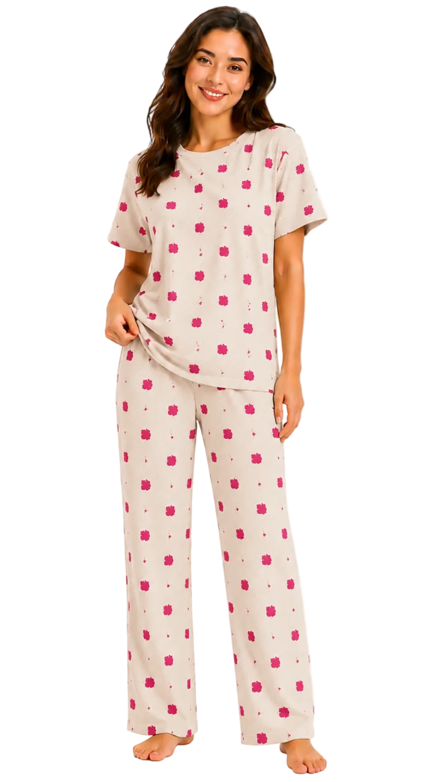 Woman wearing a cream pajama set with a pink pattern