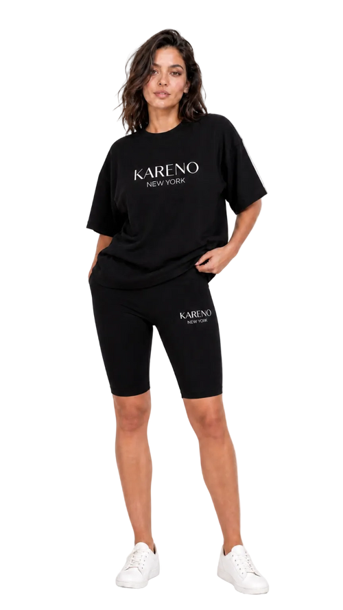 Woman wearing black 'Kareno New York' t-shirt and shorts on a white background