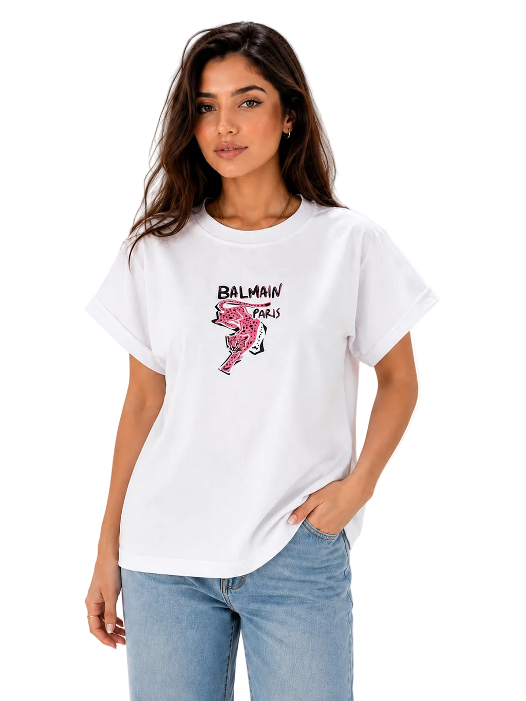 A woman modeling a white Balmain Paris graphic t-shirt with a pink flamingo print and black logo text, paired with light blue jeans against a plain white background.