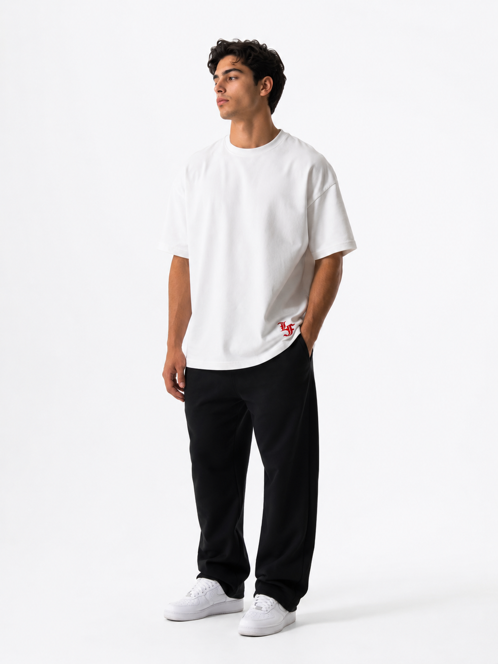Male model wearing a white oversized premium cotton t-shirt with embroidered red LF logo on a clean white studio background.