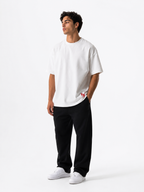 Male model wearing a white oversized premium cotton t-shirt with embroidered red LF logo on a clean white studio background.