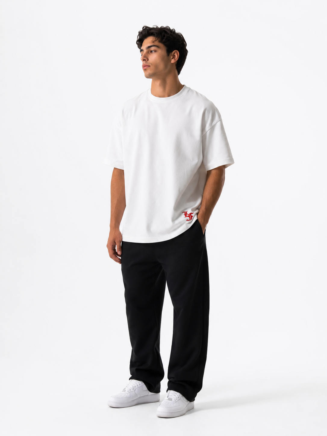 Male model wearing a white oversized premium cotton t-shirt with embroidered red LF logo on a clean white studio background.
