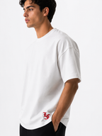 Male model wearing a white oversized premium cotton t-shirt with embroidered red LF logo on a clean white studio background.