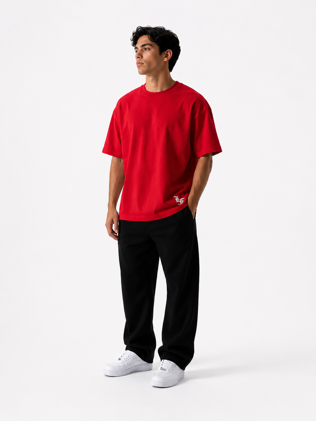 Male model wearing a red oversized premium cotton t-shirt with embroidered white LF logo on a clean white studio background.
