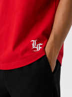 Male model wearing a red oversized premium cotton t-shirt with embroidered white LF logo on a clean white studio background.