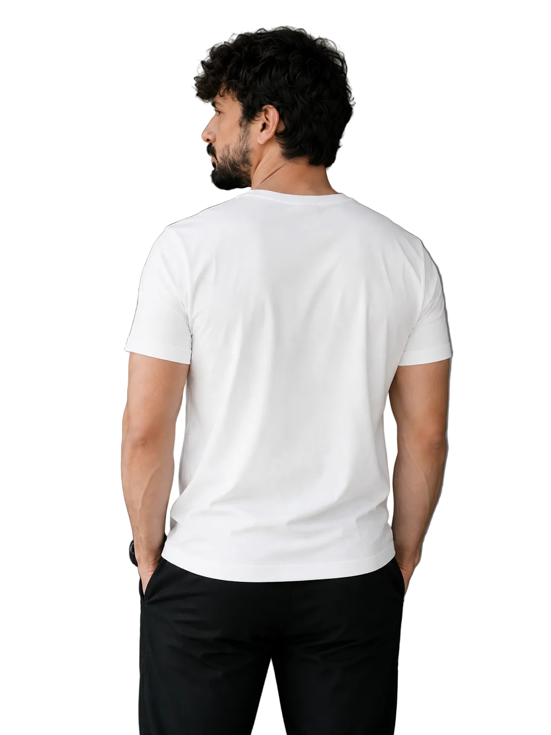 A man viewed from behind wearing a plain white short-sleeve crewneck t-shirt and black pants, standing in a minimalist indoor setting with a gray wall and a potted plant.