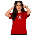 A woman modeling a red short-sleeve t-shirt with a white printed 'DOLCE&GABBARAGA DC MILANO' logo on the chest, set against a plain light gray background.