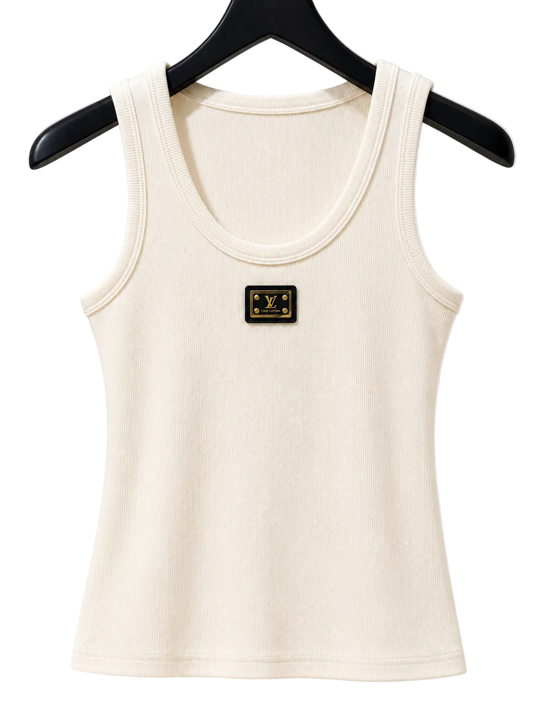 An off-white ribbed tank top with a small black and gold chest patch, hanging on a black hanger against a warm beige background with soft window shadows.
