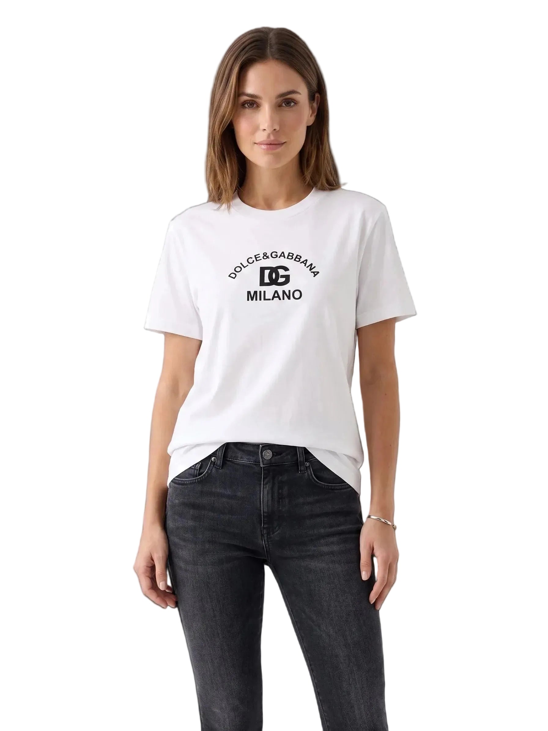 A woman modeling a white short-sleeve t-shirt with a black 'Dolce & Gabbana Milano' logo printed on the chest, paired with dark gray jeans, against a plain white studio background.