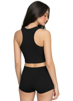 A woman shown from the back wearing a black ribbed crop top and matching high-waisted shorts against a plain light gray studio background.