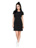 A woman modeling a black short-sleeve mini dress with white sneakers against a light gray studio background.