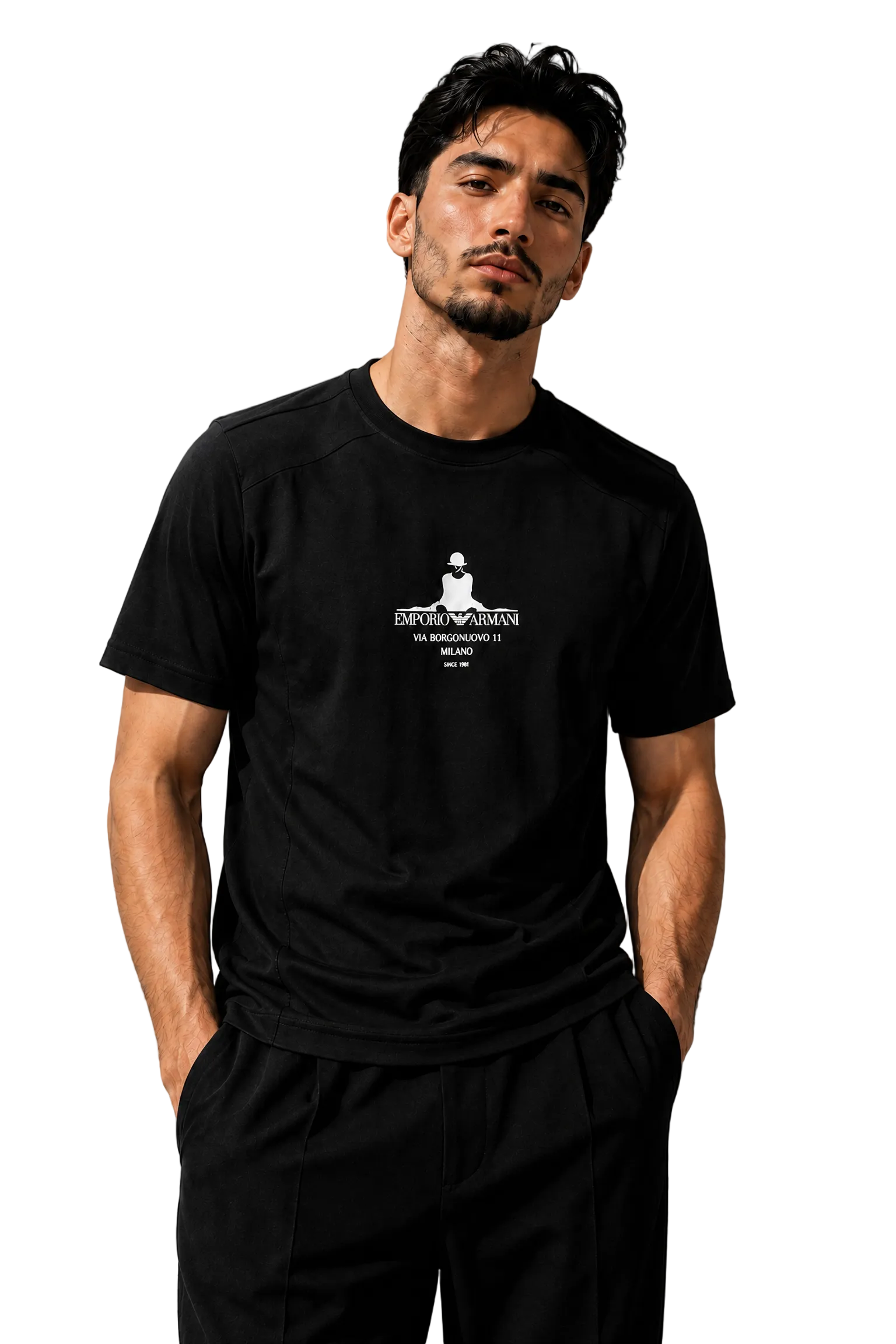 A man wearing a black short-sleeve t-shirt with a white graphic print on the chest, paired with black pants, standing against a textured gray wall.