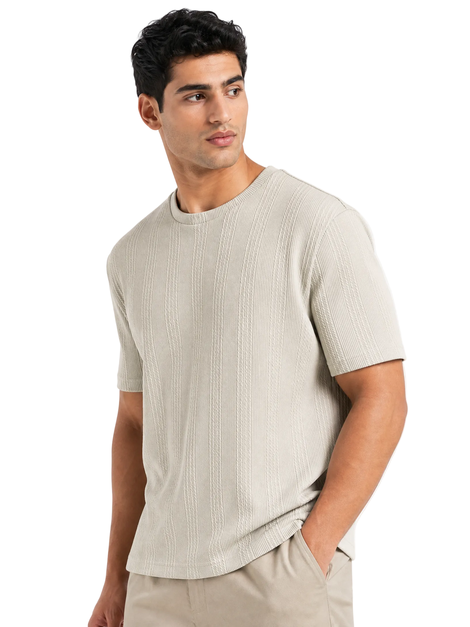 A man wearing a light beige short-sleeve crewneck knit shirt with vertical textured stripes, paired with matching beige trousers, set against a plain white background.