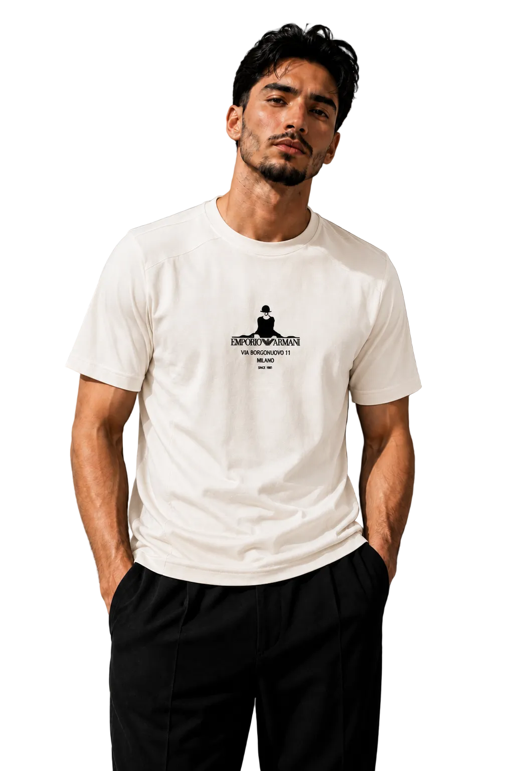 A man wearing a white crew-neck t-shirt with a black graphic print on the chest, paired with black pants, standing against a textured gray wall.