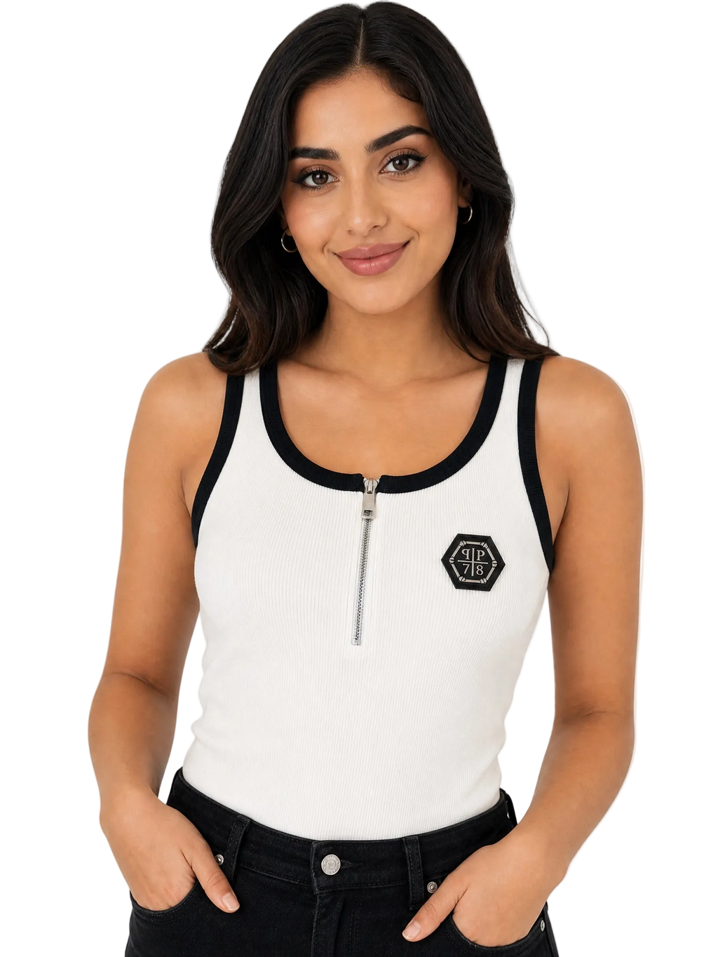 A woman modeling a white ribbed tank top with black trim, a half-zip neckline, and a black hexagonal logo patch on the left chest, paired with black jeans against a plain white background.