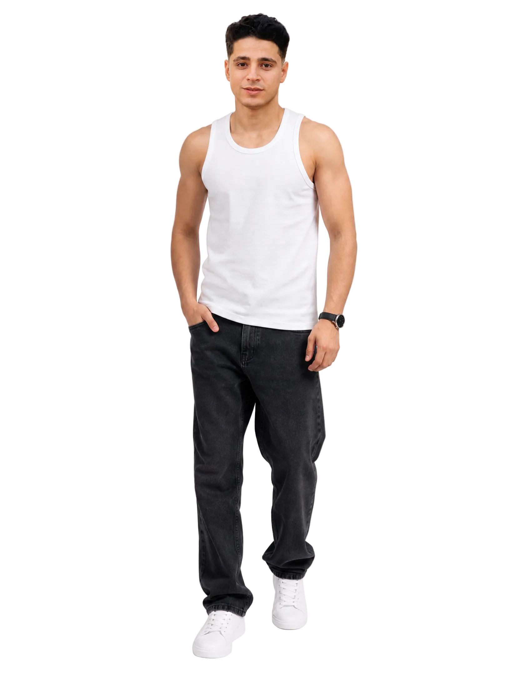 A man modeling a white sleeveless tank top paired with dark gray jeans and white sneakers, standing against a light gray studio background.