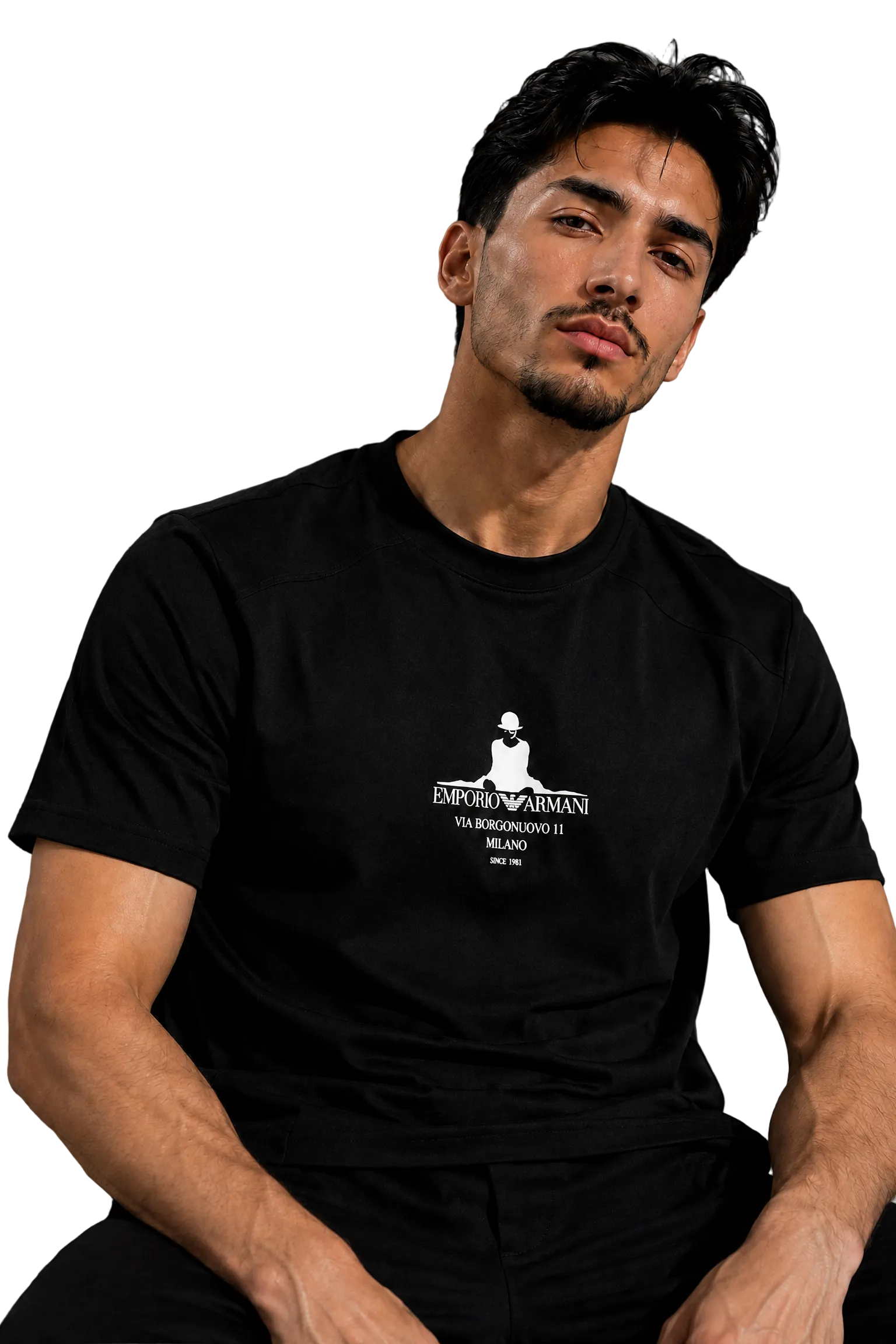 A man wearing a black short-sleeve t-shirt with a white graphic print on the chest, sitting in a black leather chair against a gray background.