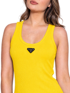 A close-up of a woman wearing a bright yellow ribbed tank top with a black triangular Prada logo patch centered below the neckline, against a plain white background.